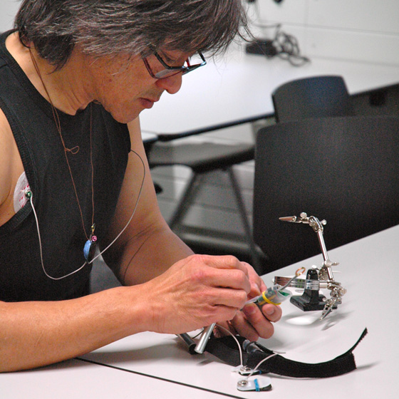 OPTIMI project leader Dennis Majoe working on an EEG sensor and wearing an ECG sensor
